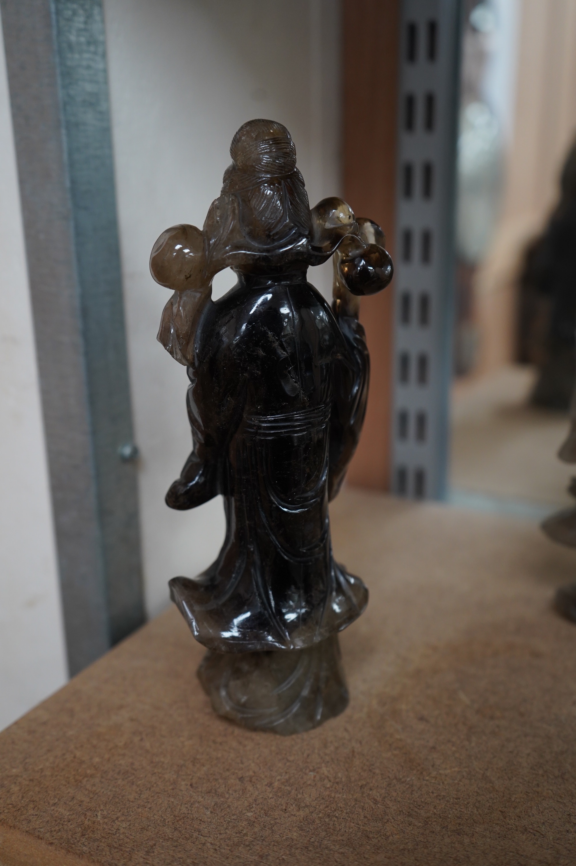 A 19th century Chinese smoky quartz figure of a lady holding a prunus branch, 19.5cm high. Condition - base and prunus branch broken one side and re-polished